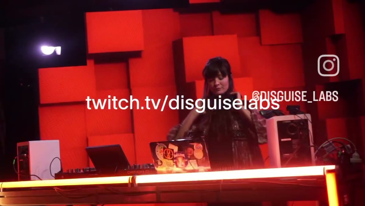 DJ set against a red voxel cube wall, streamed on Twitch