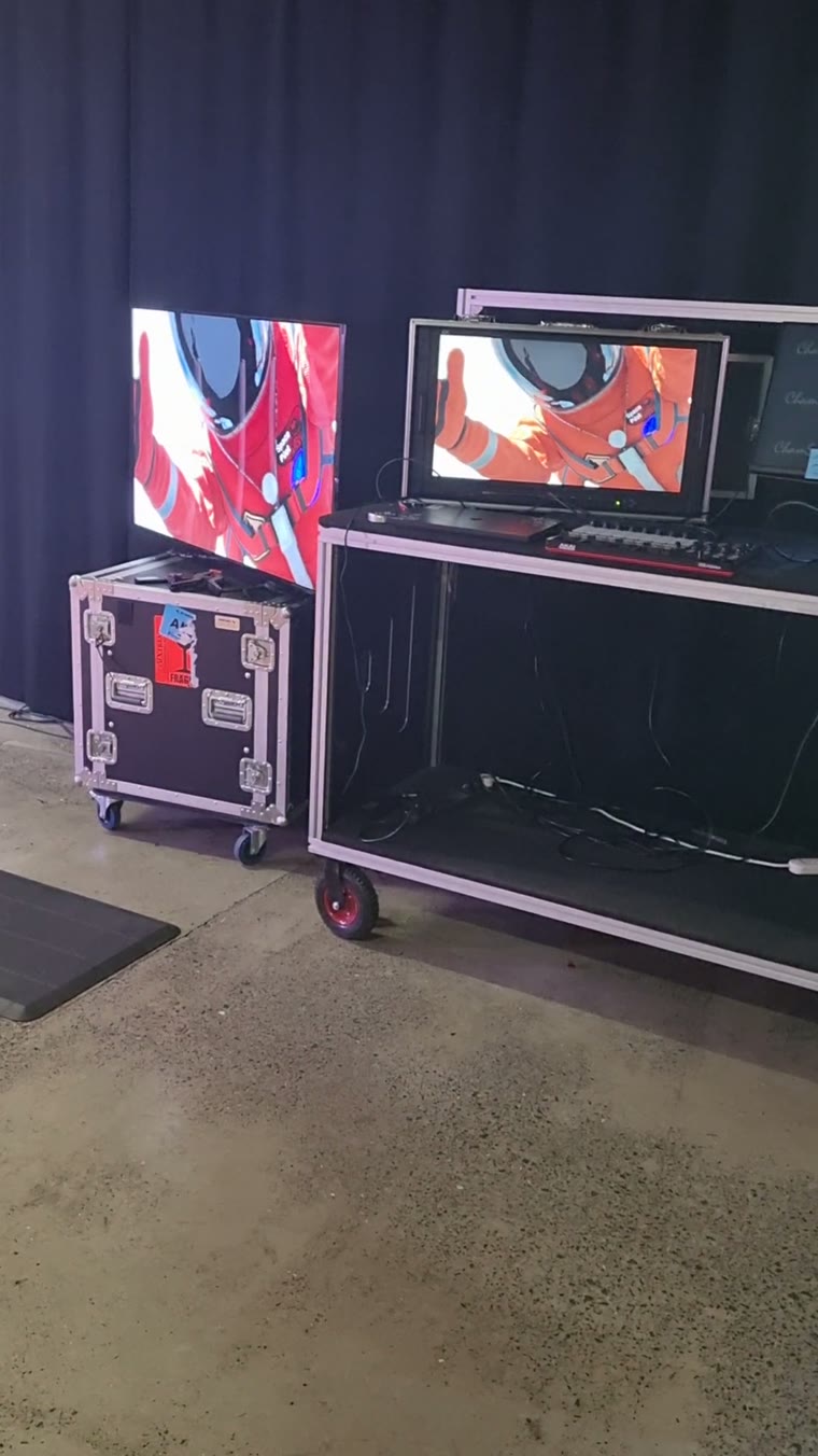 On-site rig: screens on road cases showing the live mocap character