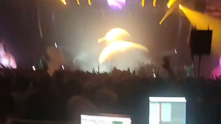 Festival stage with beams and a giant illuminated inflatable