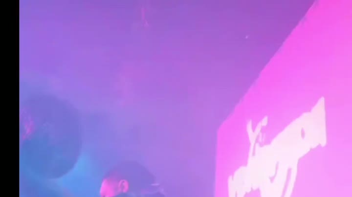 Club night with projected visuals in haze